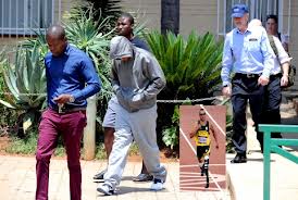 Being led away by police.